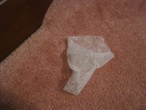 A dryer sheet on the floor.